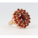 A yellow metal 9ct garnet cluster ring, 4 grams, size I 1/2
