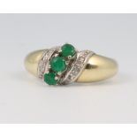 A yellow metal 14ct emerald and diamond ring, size P, 4.9 grams