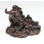 An 18th/19th Century fruitwood carving of a buffalo surrounded by monkeys, lions, shi shi, horses