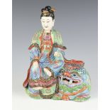 A 19th Century famille rose figure of Bodhisattva seated on a buddhistic lion decorated in