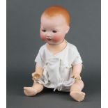 An Armand Marseille bisque headed doll stamped AM Germany 351 4/6.K, having open and closing eyes
