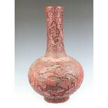 An impressive 19th Century Qing Dynasty cinnabar lacquered bottle vase, decorated with panels of