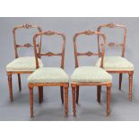 A set of 4 Victorian light oak bar back dining chairs with carved mid rails and upholstered seats,