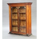 An Edwardian mahogany "shop" fitting with moulded cornice, fitted shelves enclosed by pair of arched