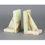 A pair of Art Deco green onyx bookends 15cm h x 10cm w x 8cm d Both have slight chips to the bases