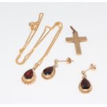A 9ct yellow gold garnet set pendant and chain, a pair of ditto earrings and a cross, 8.7 grams