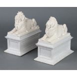 A pair of resin bookends in the form of recumbent lions on rectangular bases 19cm h x 19cm x 10cm