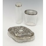 An Edwardian repousse cut glass silver lid jar with scroll decoration Birmingham 1906 14cm (holed)