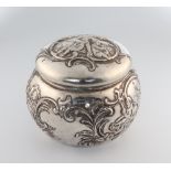 A Victorian circular repousse silver trinket box decorated with cavorting cherubs import marks for