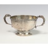 A silver Arts and Crafts style 2 handled bowl with mythical beast handles and strap work
