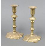 A pair of 17th Century style brass petal based candlesticks 22cm x 12cm