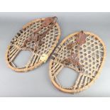A pair of 1930's wooden and hide snowshoes 50cm x 34cm