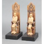 A pair of 1930's carved oak bookends in the form of seated monks 26cm h