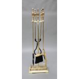 An Adam's style gilt metal 4 piece fireside companion set comprising poker, tongs, shovel and