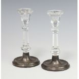 A pair of cut glass candlesticks with silver bases Birmingham 1990, 16cm