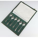 A set of Georgian style silver tea spoons with decorated backs - bird cage, dragon, cockerell,