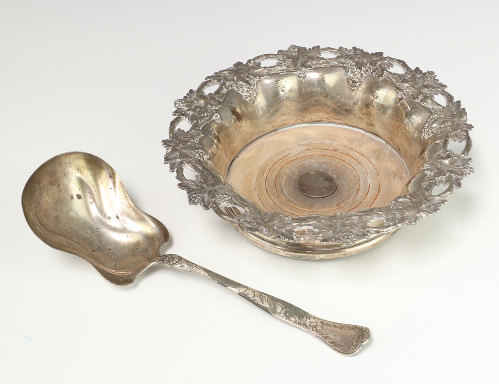 A Sterling silver serving spoon 75 grams, a plated repousse champagne coaster