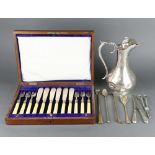 An Edwardian silver plated engraved ewer, a cased set of fish eaters a plated cheese scoop, grape