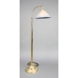 An Edwardian style adjustable gilt metal standard lamp with opaque glass shade raised on a