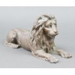 A 19th Century bronze figure of a recumbent lion 15cm x 30cm x 9cm
