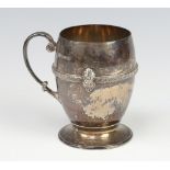 A silver Arts and Crafts mug with strap work decoration and fancy handle, Birmingham 1931, maker
