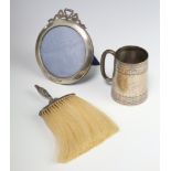 A Victorian silver christening mug Chester 1899, a ditto circular photograph frame 1906 and a silver