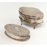 An Edwardian oval repousse silver trinket box Birmingham 1901 7cm, a silver trinket box on raised