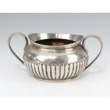 A Victorian demi-fluted silver twin handled sugar bowl London 1895, 14cm, 202 grams The body is