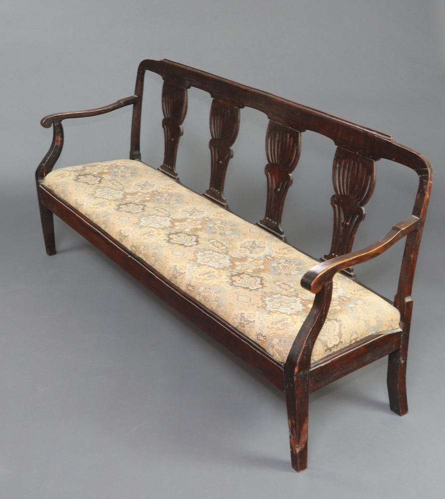 A 19th Century Continental mahogany double chair back settee with pierced vase shaped slat back