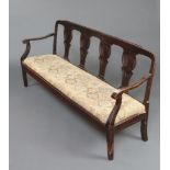 A 19th Century Continental mahogany double chair back settee with pierced vase shaped slat back