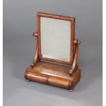 A Victorian rectangular plate dressing table mirror, raised on a shaped base fitted 2 drawers, on