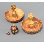 A pair of olive wood campaign style candlesticks 8cm x 9cm together with a small turned wooden