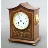 A French 8 day striking mantel clock with 10cm enamelled dial, Roman numerals, contained in a shaped