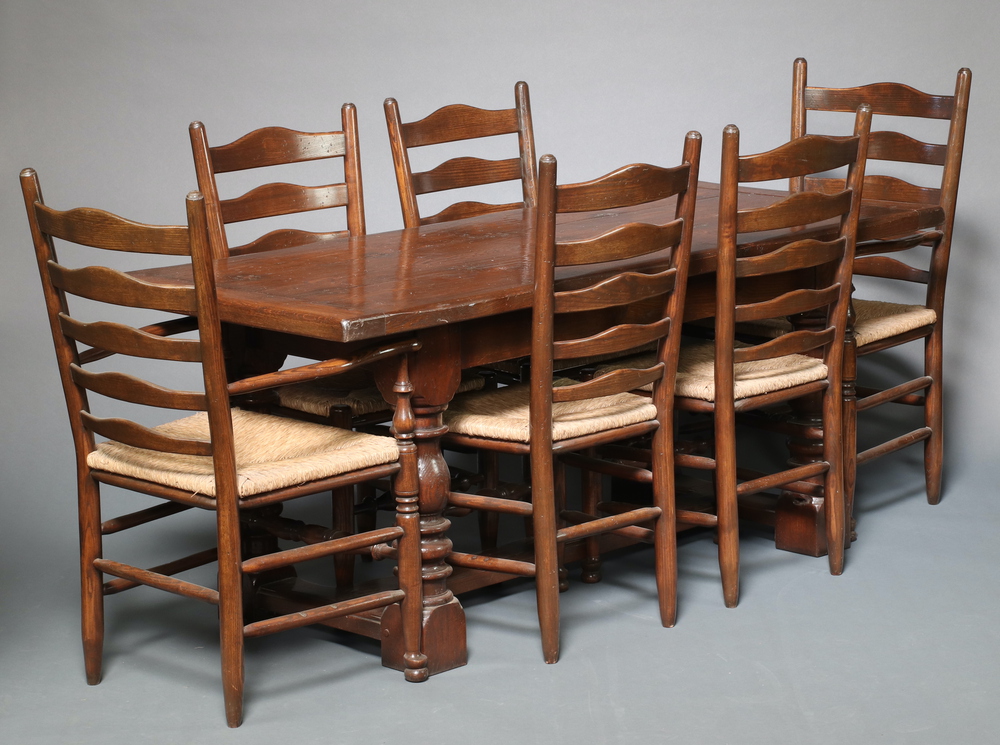 A 17th Century style oak dining suite comprising refectory dining table, the top formed from 3