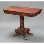 A 19th Century mahogany D shaped card table raised on a ring turned column with quatrefoil base,