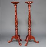 A pair of Georgian style spiral turned mahogany torcheres, raised on pillar and tripod base 133cm