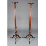 A near pair of Edwardian Chippendale style turned and reeded mahogany torcheres, raised on a