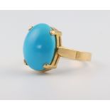 A yellow metal stamped 18ct turquoise set ring, size M