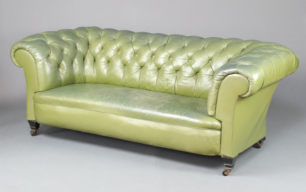 A 19th Century Chesterfield upholstered in green buttoned leather, raised on square supports 71cm