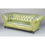 A 19th Century Chesterfield upholstered in green buttoned leather, raised on square supports 71cm