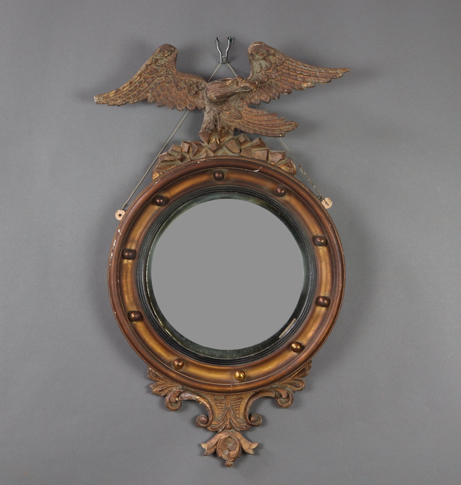 A 19th Century convex circular plate mirror contained in a gilt ball studded frame surmounted by