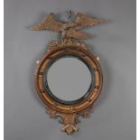 A 19th Century convex circular plate mirror contained in a gilt ball studded frame surmounted by