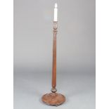 A Georgian style turned and fluted mahogany standard lamp on spreading foot 125cm h x 33cm diam.