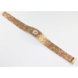 A lady's 9ct yellow gold Milner wristwatch on a textured bracelet 30 grams including the glass