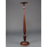 A William IV turned mahogany bedpost torcher with saucer top, raised on a turned column and