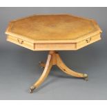 A Georgian style octagonal pine drum table with brown leather inset top, fitted 4 frieze drawers,