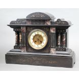 A French 8 day striking mantel clock with 11cm enamelled dial Roman numerals, contained in a black