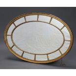 A 19th Century oval plate wall mirror contained in a decorative painted gilt frame 81cm x 122cm