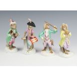 A German porcelain monkey band comprising 4 figures holding instruments raised on Rococo bases