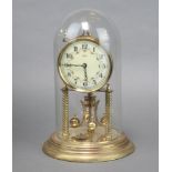 Kundo, a 400 day clock with enamelled dial and Roman numerals in a gilt case, complete with glass
